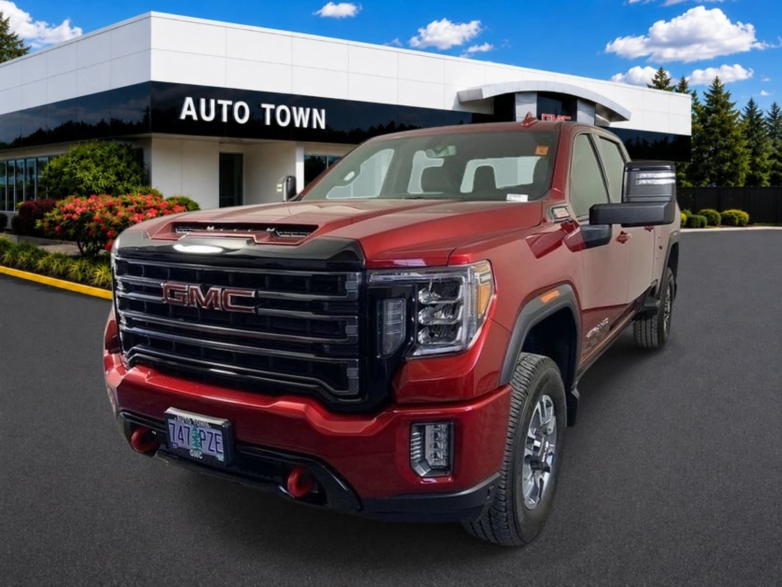 2022 GMC Sierra 2500 HD Crew Cab Standard Box 4-Wheel Drive AT4 in Cayenne Red Tintcoat — front three-quarter view